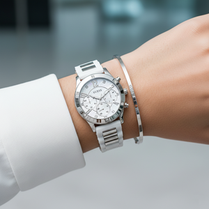 Female model wearing Guess W1234L1 hybrid strap watch with a casual white sporty outfit
