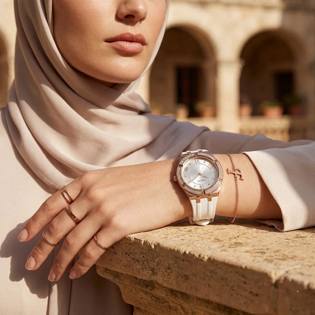 Elegant woman wearing Guess Cosmo GW0034L2 women's quartz battery watch with rose gold case and luxury white rubber strap