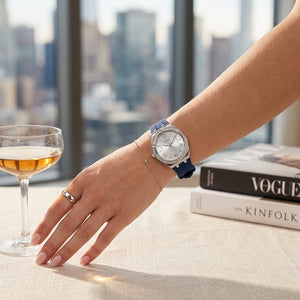 Close up of Guess Cosmo GW0034L5 women's quartz battery watch on wrist showing silver sunray dial and luxury crystal bezel