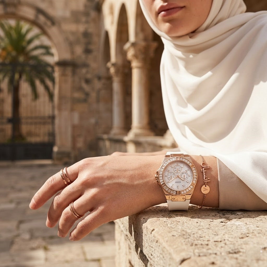 Elegant woman wearing Guess Venus GW0118L4 women's quartz battery watch with rose gold case and luxury white rubber strap