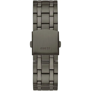 A dark gray metallic stainless steel watch band with a brushed finish and the GUESS brand name embossed on the clasp, shown against a plain white background.