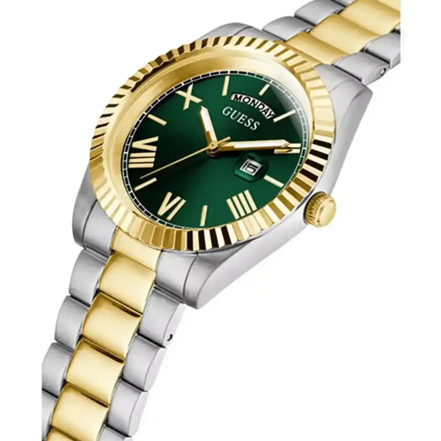A two-tone stainless steel and gold wristwatch by Guess with a dark green dial, gold-tone bezel and hands, and a matching two-tone link bracelet on a white background.