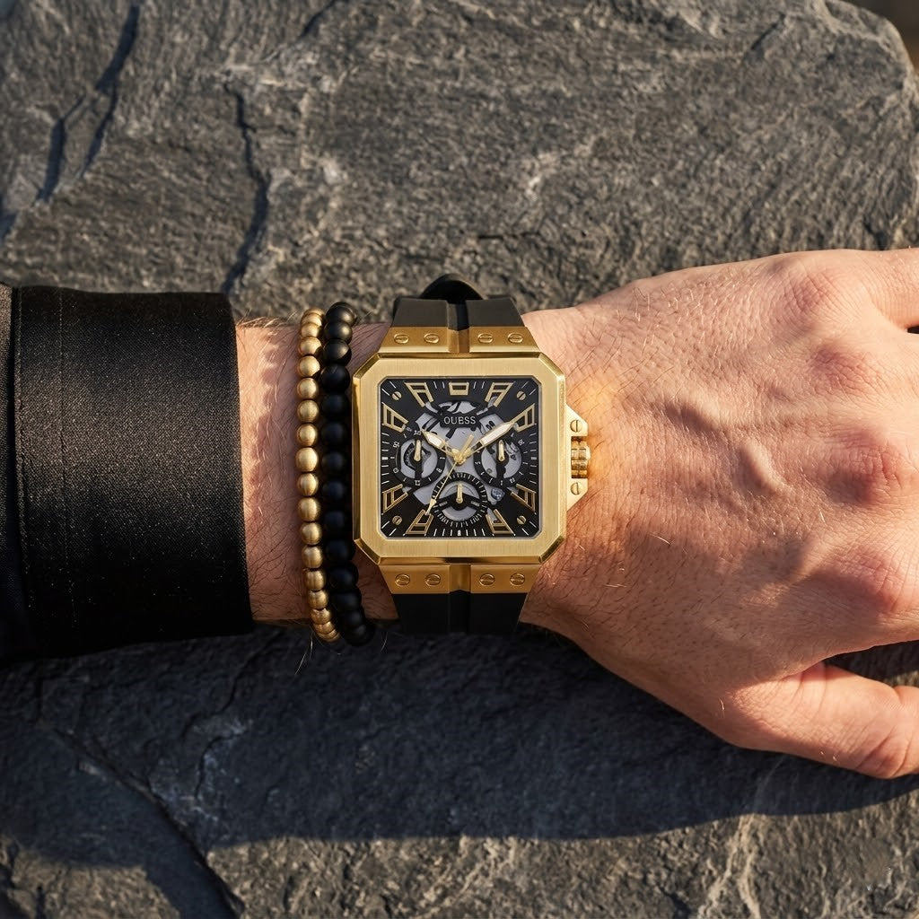 Close up of Guess LEO GW0637G2 men's quartz battery watch on wrist showing bold black dial and luxury crystal bezel