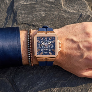 Elegant man wearing Guess LEO GW0637G3 men's quartz battery watch with rose gold case and luxury crystal animal print strap
