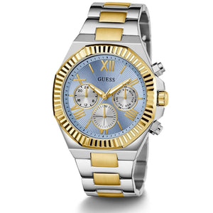 A two-tone stainless steel and gold Guess analog watch with a light blue dial, Roman numeral XII, and three subdials on a white background.