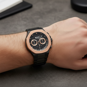 Detailed macro view of the black textured dial and brushed gold-tone bezel of Hugo Boss 1514090