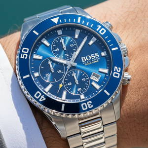 Close up shot of Hugo Boss Admiral 1513907 watch on wrist showing the blue sunray dial and rotating bezel