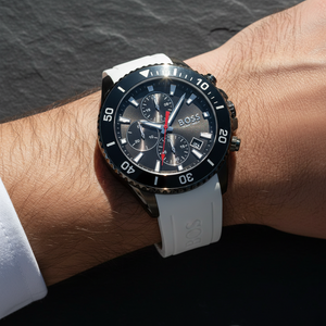 Close up shot of Hugo Boss Admiral 1513966 watch on wrist showing the black dial and white strap contrast