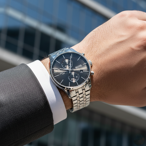 Male model wearing Hugo Boss Associate 1513869 silver watch with a formal business suit