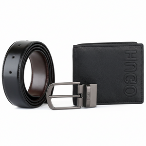 Close-up of a Hugo Boss black genuine leather belt featuring a polished silver-tone pin buckle with engraved branding