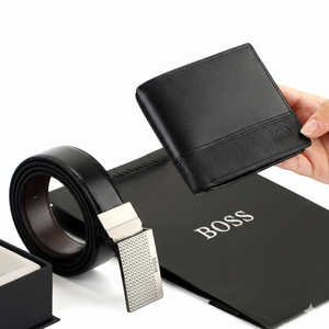 Hugo Boss black leather wallet and belt gift set displayed with an official Hugo Boss branded paper shopping bag for a premium gifting experience