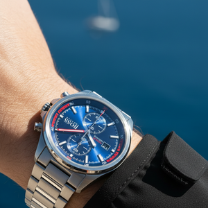 Close up shot of Hugo Boss Globetrotter 1513823 watch on wrist showing the blue dial and red details