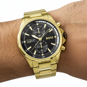 Close up shot of Hugo Boss Globetrotter 1513932 watch on wrist showing the 46mm gold case