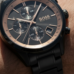 Close up shot of Hugo Boss Grand Prix 1513578 watch on wrist showing the black dial and gold hands