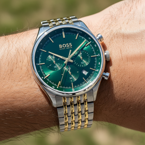 Close up shot of Hugo Boss Gregor 1514081 watch on wrist showing the green sunray dial and gold details