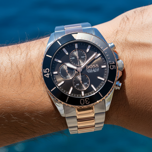 Close up shot of Hugo Boss Ocean Edition 1513705 watch on wrist showing the grey sunray dial and rotating bezel
