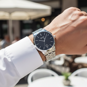 Male model wearing Hugo Boss Officer 1513614 watch with a formal business suit