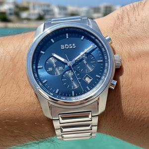 Close up shot of Hugo Boss Trace 1514007 watch on wrist showing the blue dial and date window