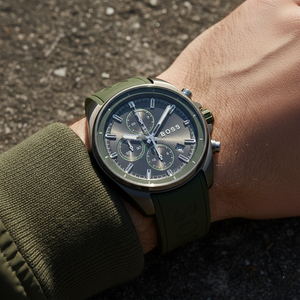 Close up shot of Hugo Boss Volane 1513952 watch on wrist showing the dark grey dial and green strap