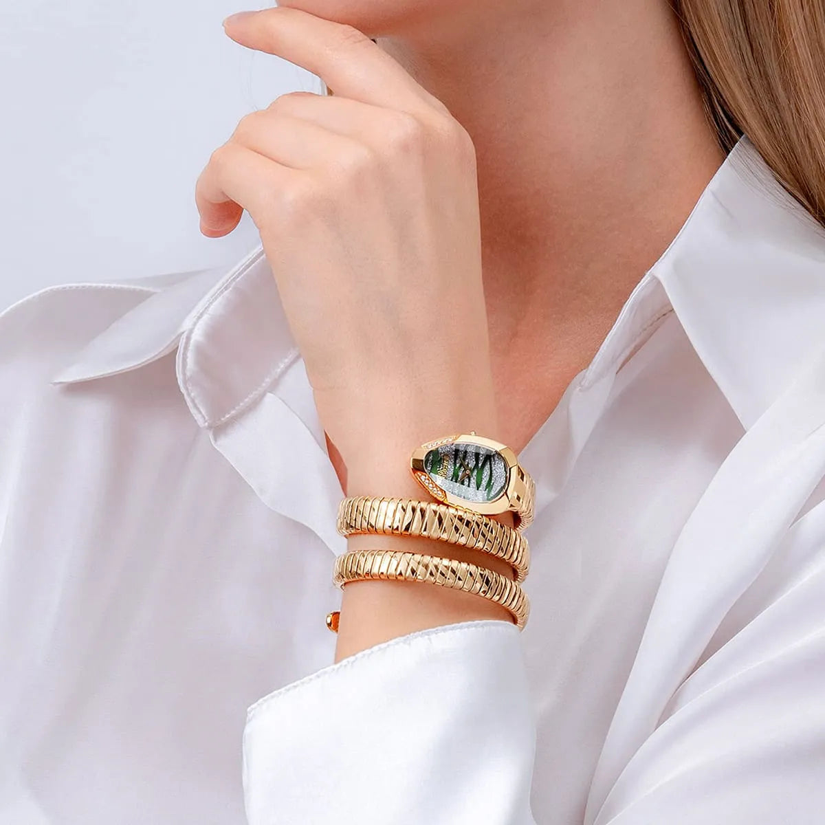 Close up shot of Just Cavalli JC1L226M0035 on wrist showing the elegant gold snake design coiled three times and green silver dial from Luxury Hub Store