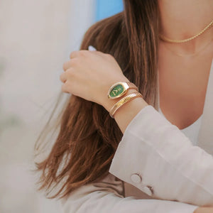Lifestyle photo of Just Cavalli JC1L229M0035 showing the luxurious gold wrap watch on a woman's wrist in a glamorous setting from Luxury Hub Store