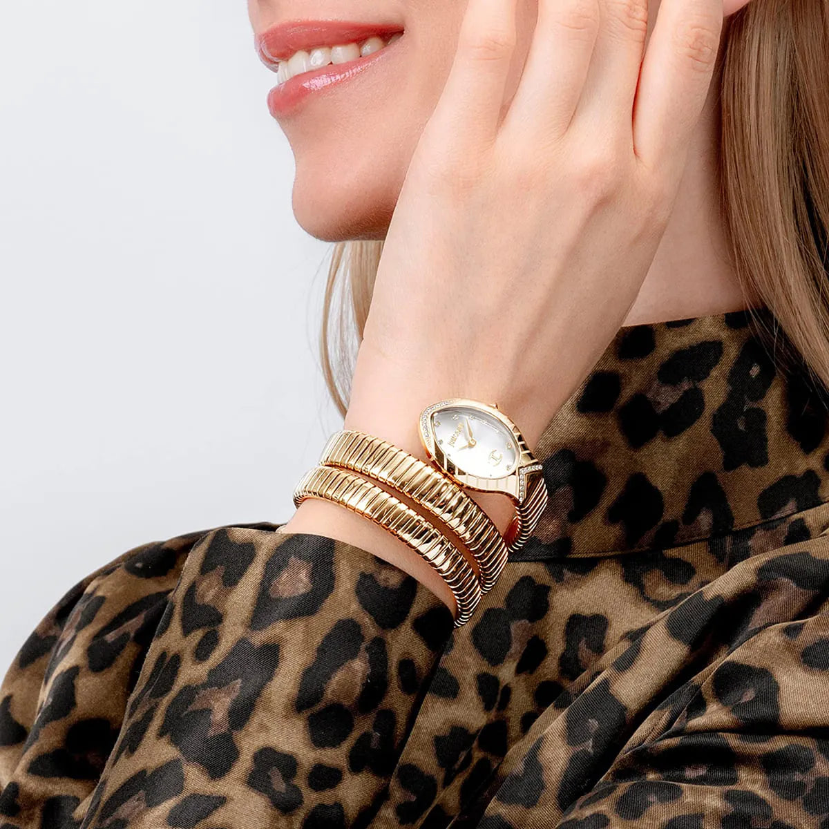 Close up shot of Just Cavalli JC1L229M0065 on wrist showing the elegant two-tone snake design and MOP dial with crystal indices from Luxury Hub Store