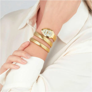 Gold bracelets on a wrist with a white background