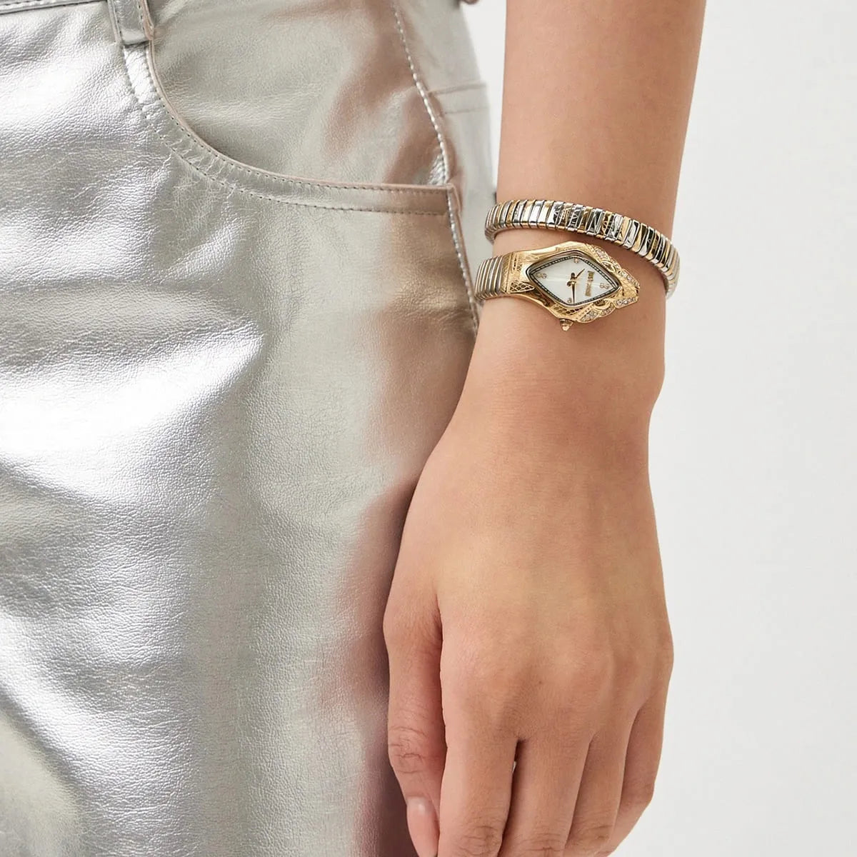 Close up shot of Just Cavalli JC1L306M0065 on wrist showing the elegant two-tone snake design and mother of pearl dial from Luxury Hub Store