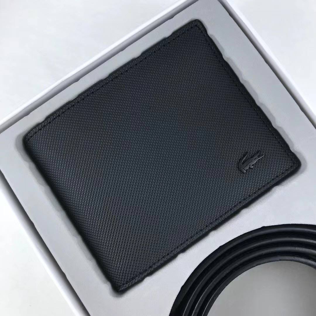Top down view of Lacoste Gift Set box containing black Piqué wallet and rolled belt strap