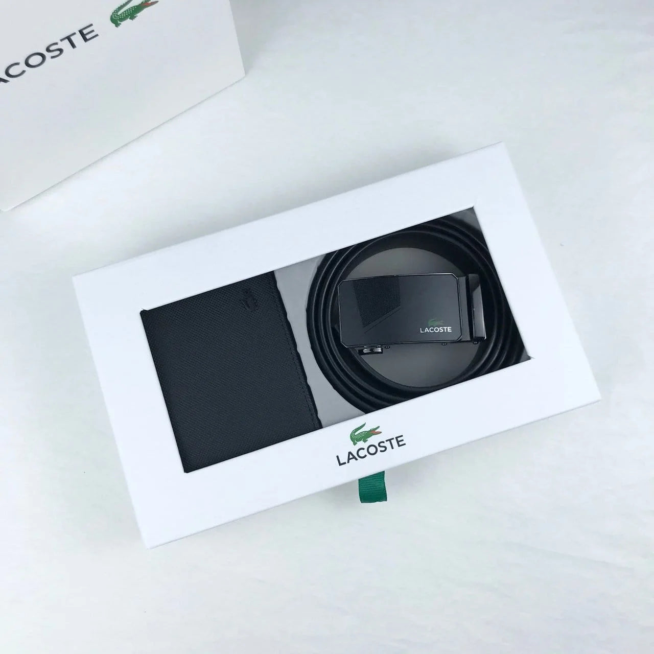 Lacoste belt and wallet set in a branded box on a white background
