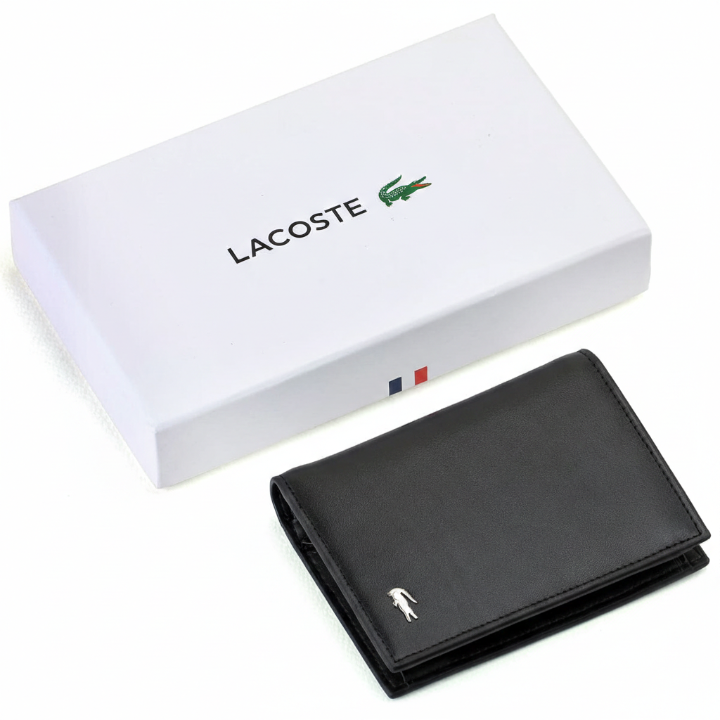 A closed Lacoste men's black smooth leather wallet featuring a silver metal crocodile logo, placed elegantly next to its matching closed white gift box