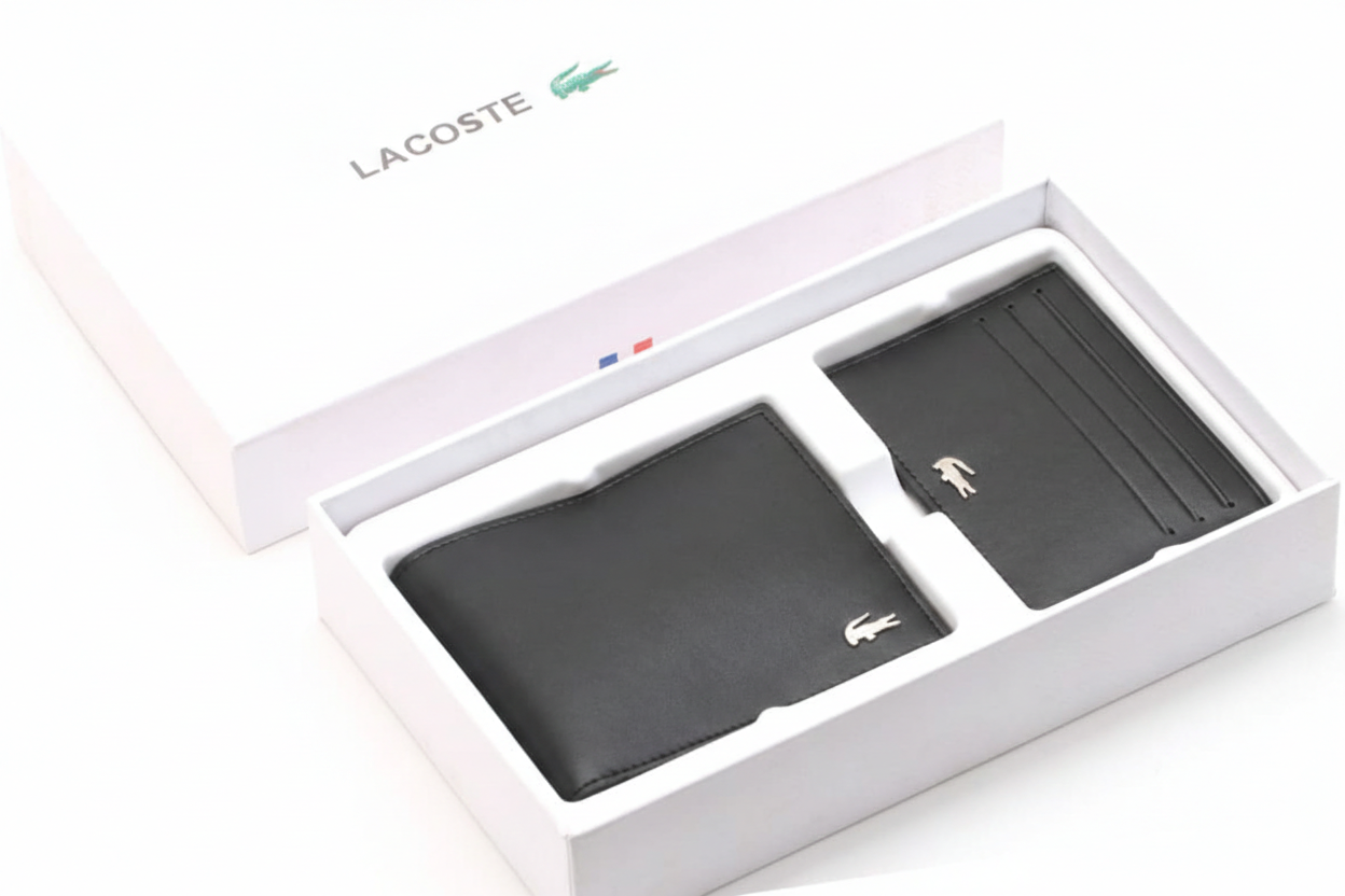 Angled perspective of a Lacoste men's black leather wallet and cardholder set securely presented inside its original white branded gift box