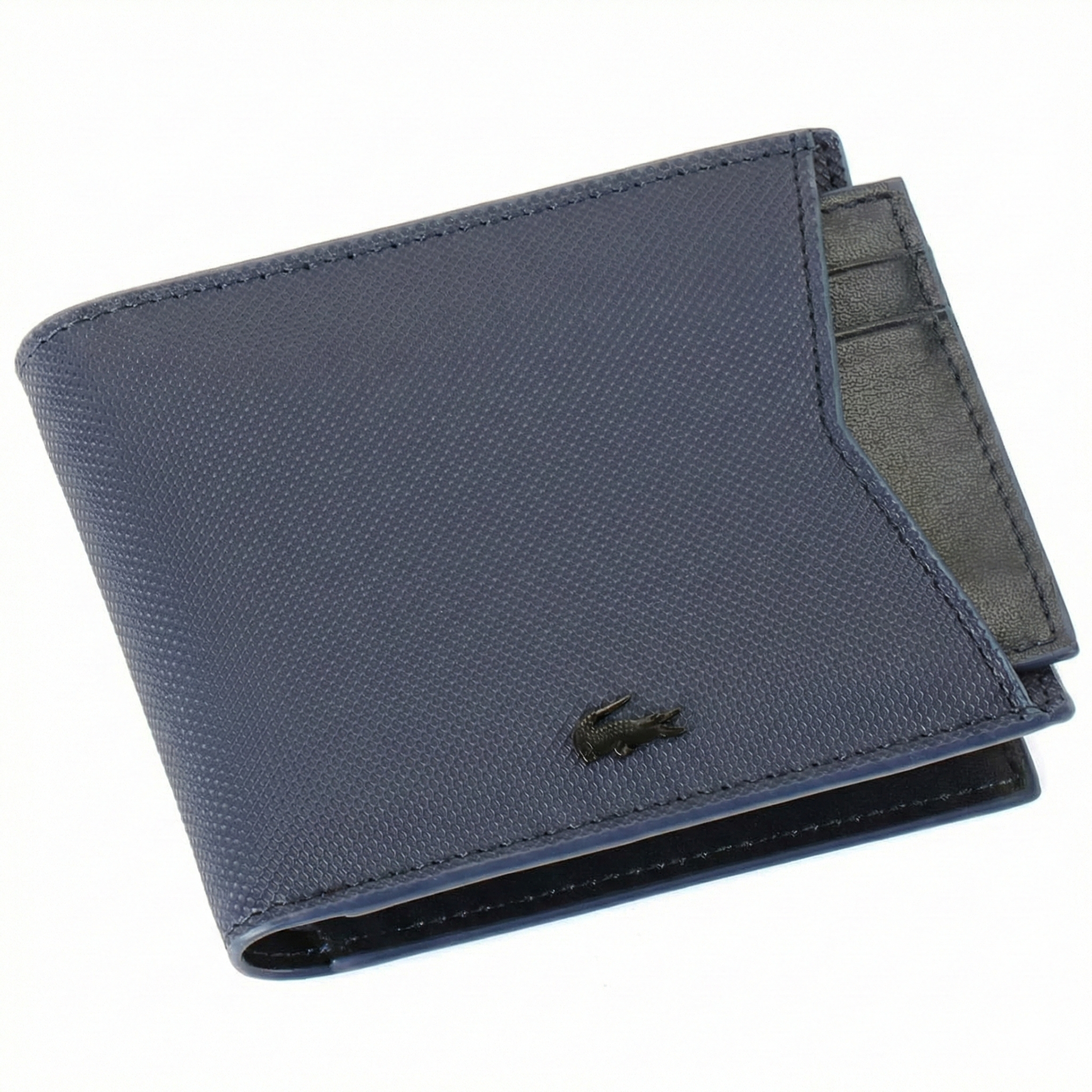 Straight-on front view of a closed Lacoste men's navy blue grained leather wallet showing the black crocodile logo and the edge of the removable card holder insert