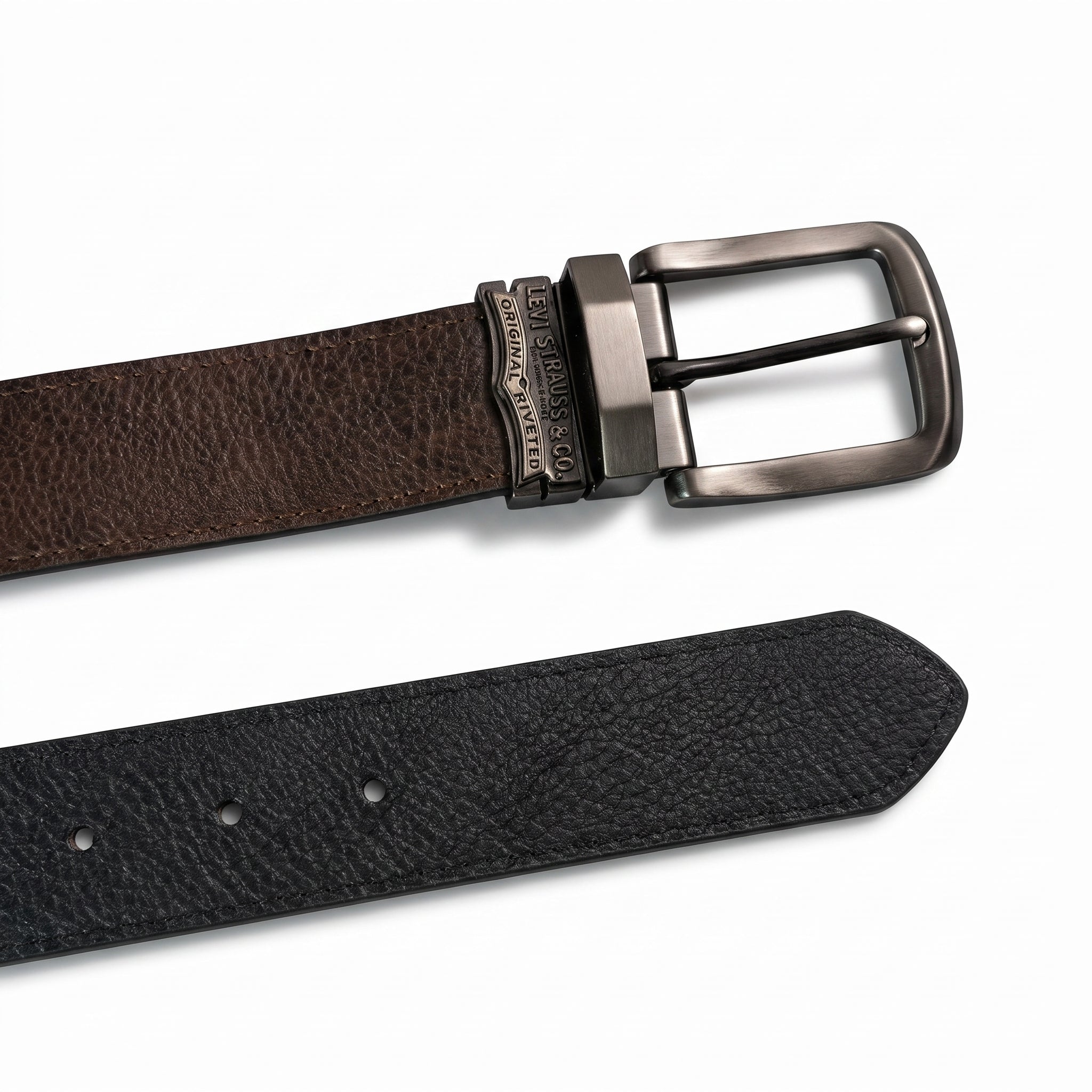 Detailed close-up of the Levi's gunmetal plaque buckle featuring the precision-engraved two-horse pull heritage logo