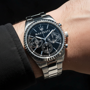 Ultra close-up of Maserati R8853100014 on model's wrist showing the black multifunction dial and sleeve detail