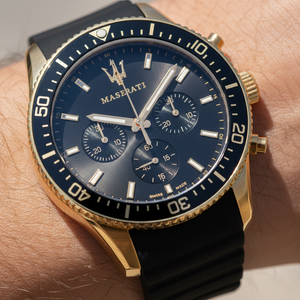 Detailed macro view of the black dial, gold Trident logo, and sub-dials of Maserati R8871640001