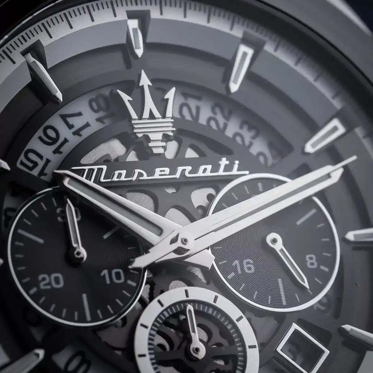 Close-up of a Maserati watch face with intricate design and brand logo.