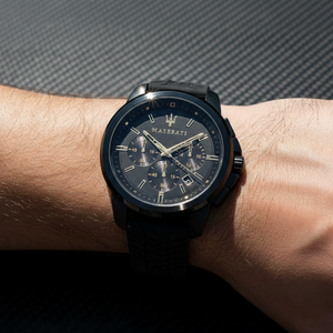 Close up shot of Maserati Successo R8871621011 watch on wrist showing the black dial and gold hands