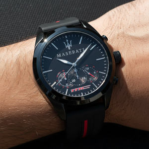 Close up shot of Maserati Traguardo R8871612004 watch on wrist showing the black dial and red strap detail