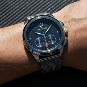 Close up shot of Maserati Traguardo R8873612006 watch on wrist showing the black dial with blue sub-dials