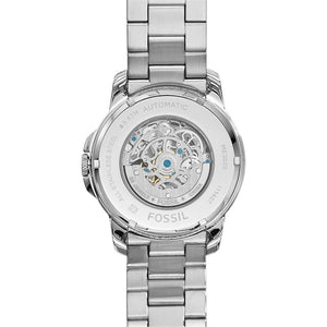 Silver Fossil watch with visible mechanical components on a white background