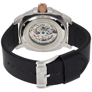 Back view of a Fossil watch with black strap and silver case on a white background