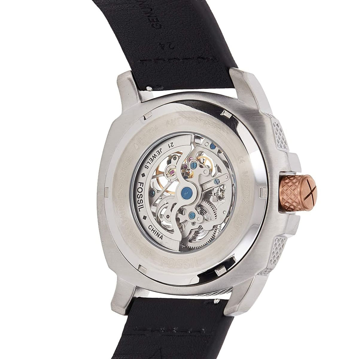 Close-up rear view of a wristwatch with a silver-toned case, transparent back showing an exposed mechanical movement, and a black strap on a white background.