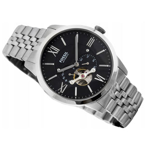 Fossil watch with black dial and silver metal band on a white background