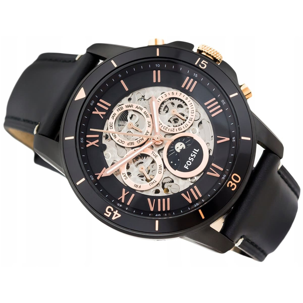 Black and rose gold Fossil watch on a white background