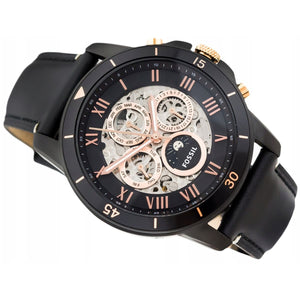 Black and rose gold Fossil watch on a white background