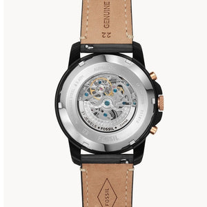 Fossil watch with brown leather strap and visible mechanical components on a white background