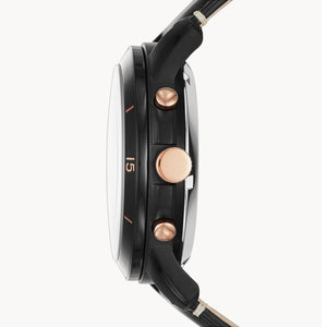 Close-up of a watch with black strap and rose gold accents on a white background