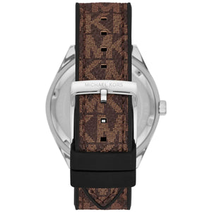 Close-up of the silver-tone pin buckle with the engraved Michael Kors branding on the brown logo-patterned rubber strap