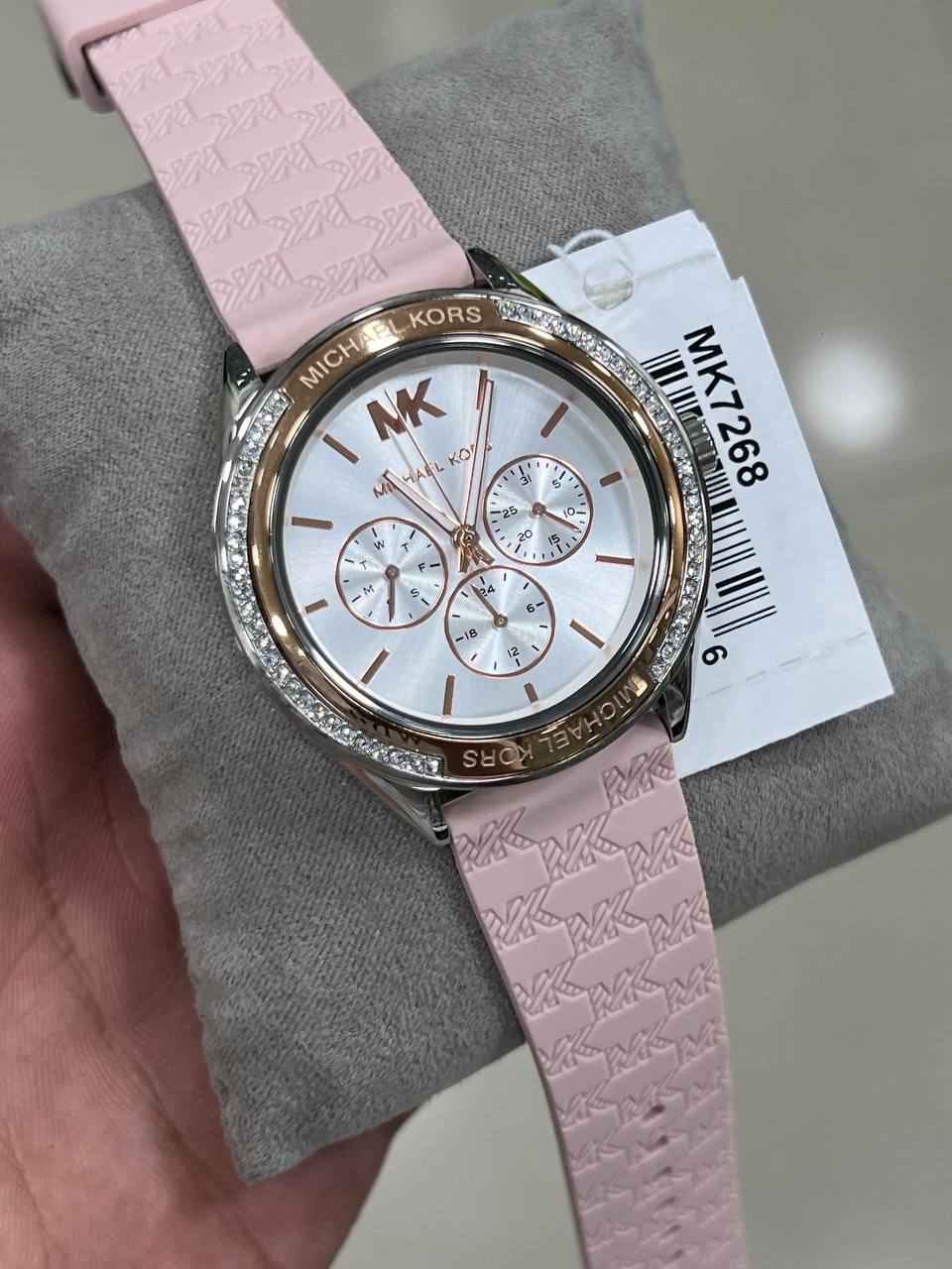 Side profile of the polished silver-tone stainless steel case and crown on the MK7268